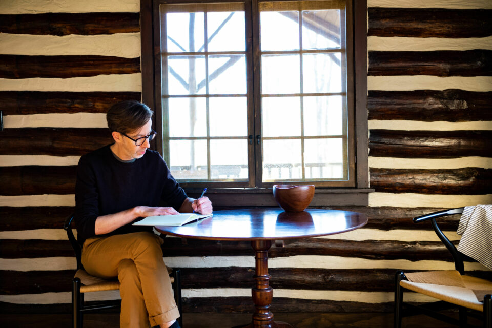 Aaron Landsman writing at table